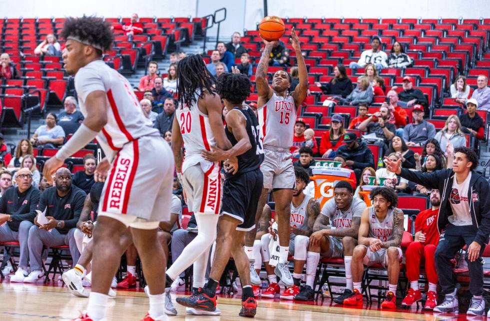 UNLV Rebels guard Luis Rodriguez (15) posts up for a three-point shot over Bethesda University ...