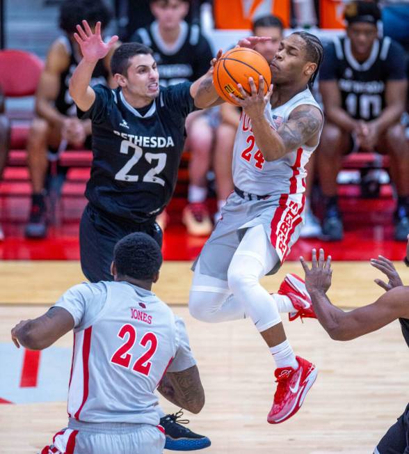 UNLV Rebels guard Jackie Johnson III (24) catches some air to the hoop against Bethesda Univers ...