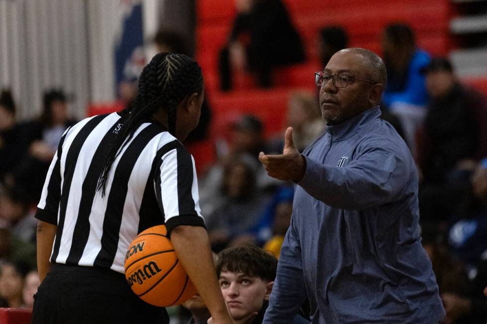Liberty head coach Kevin Soares disputes a foul charged to his team during the second half of a ...