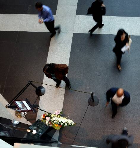 A person stands beside the memorial for slain court security officer Stan Cooper on the third a ...