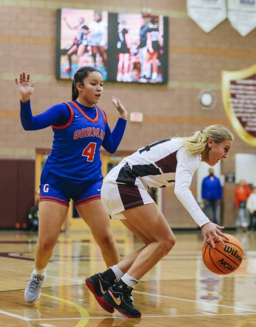 Faith Lutheran’s Kloe Abdalla (14) dribbles the ball as Bishop Gorman guard Anna Barraga ...