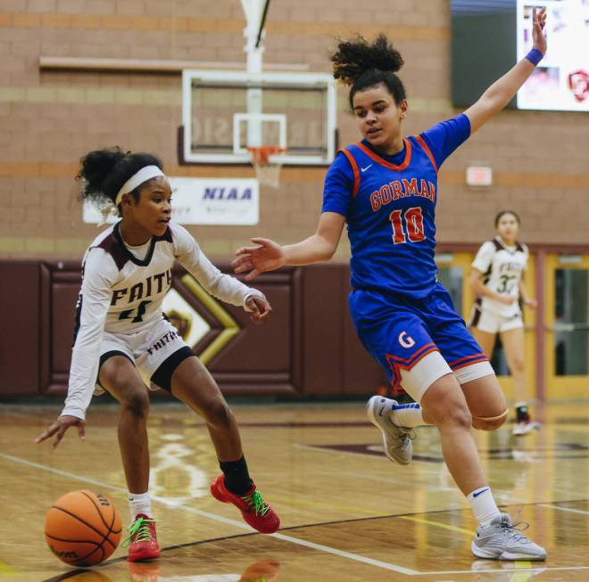 Faith Lutheran’s Tamiah Harrison (4) dribbles the ball as Bishop Gorman point guard Aali ...