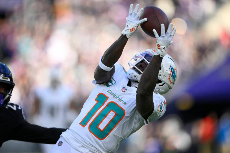 Miami Dolphins wide receiver Tyreek Hill (10) catches a pass for a first down against the Balti ...