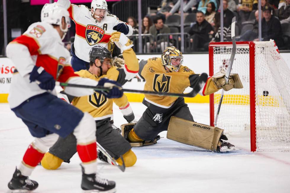 The Florida Panthers get the puck past Vegas Golden Knights goaltender Logan Thompson (36) duri ...