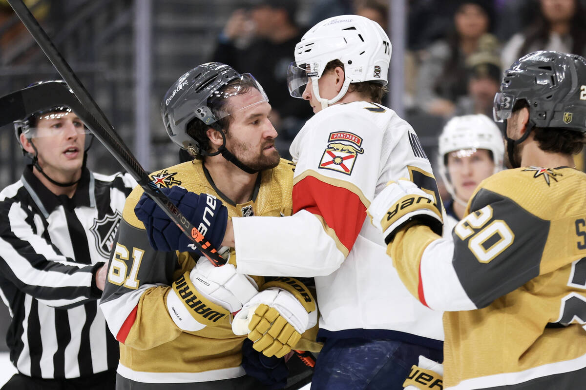 Vegas Golden Knights right wing Mark Stone (61), left, and center Chandler Stephenson (20) mix ...