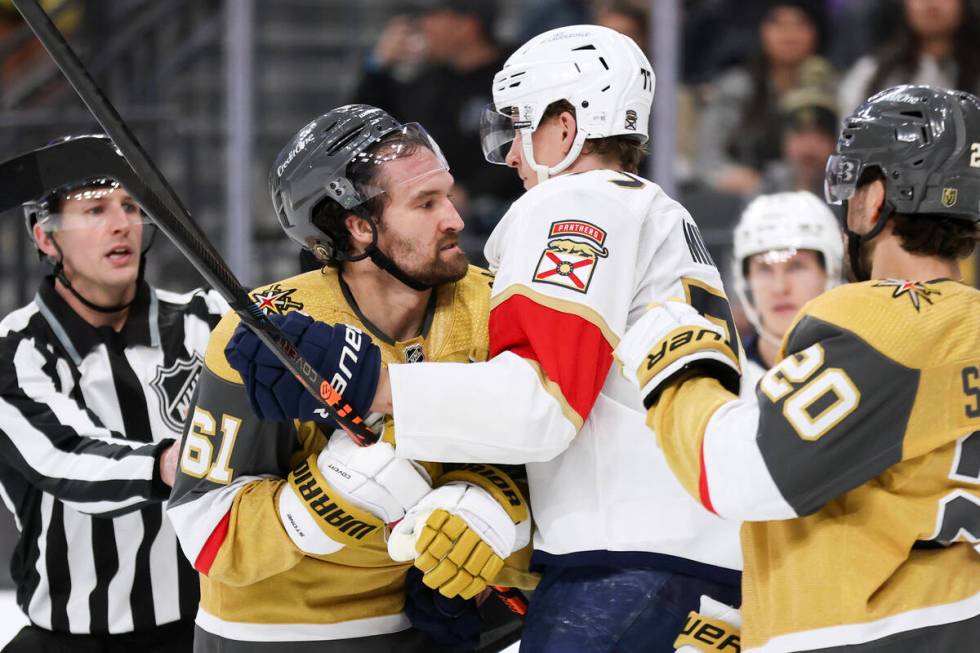 Vegas Golden Knights right wing Mark Stone (61), left, and center Chandler Stephenson (20) mix ...