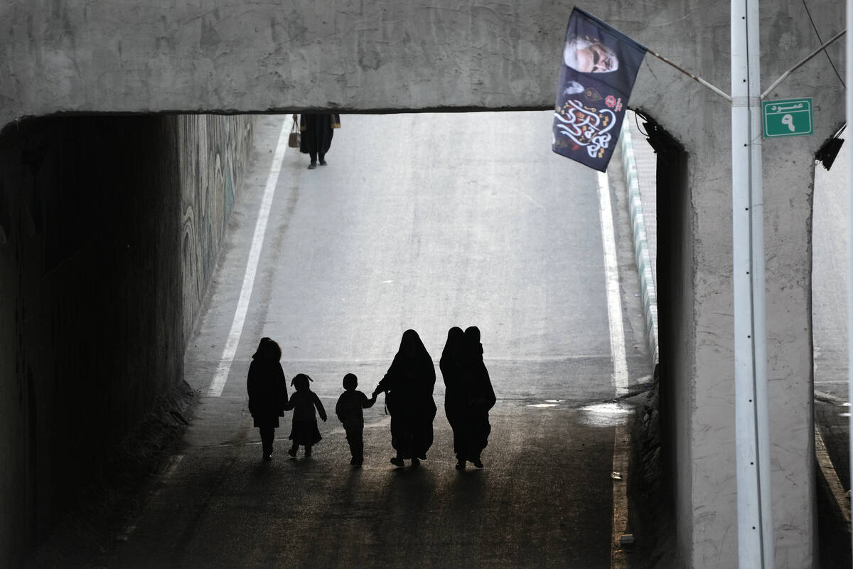 People walk towards the grave of the late Iranian Revolutionary Guard Gen. Qassem Soleimani in ...