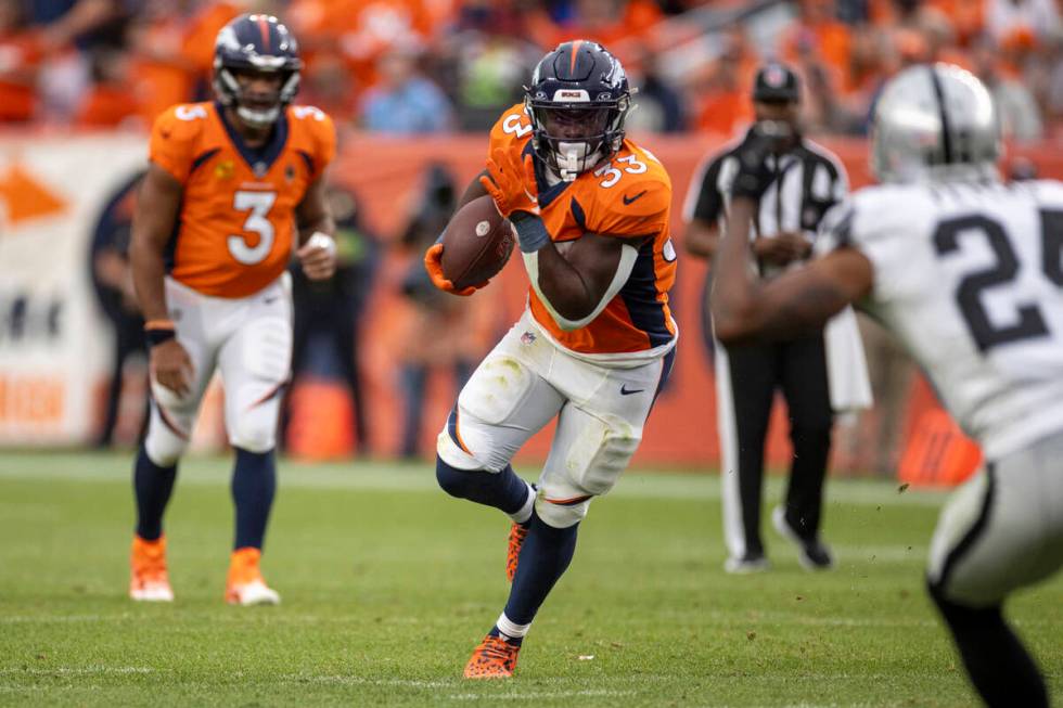 Denver Broncos running back Javonte Williams (33) rushes against the Raiders during the second ...