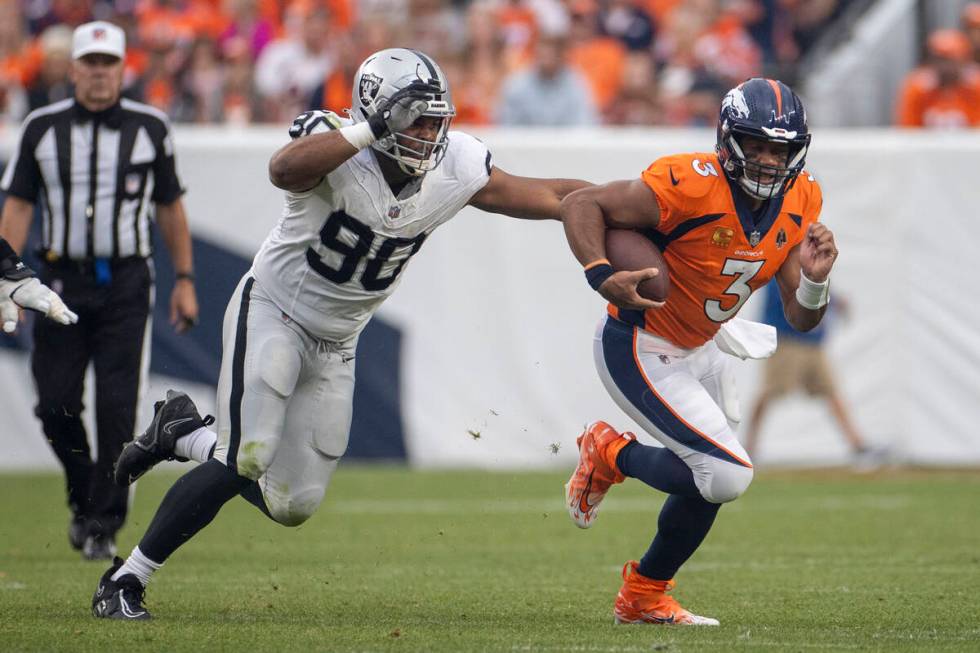 Raiders defensive tackle Jerry Tillery (90) pursues Denver Broncos quarterback Russell Wilson ( ...