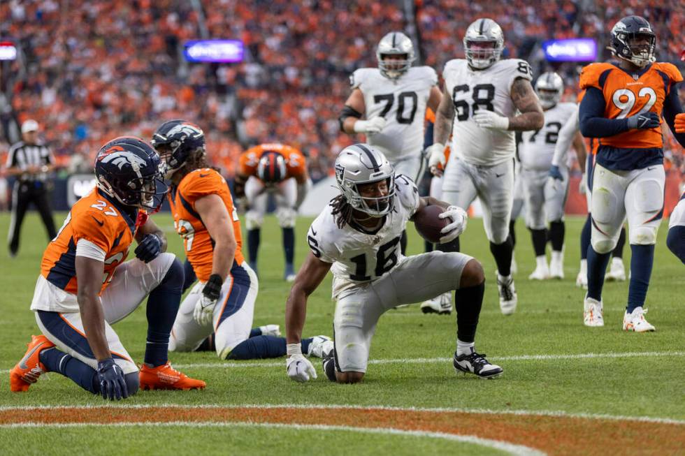 Raiders wide receiver Jakobi Meyers (16) scores a touchdown as Denver Broncos cornerback Damarr ...