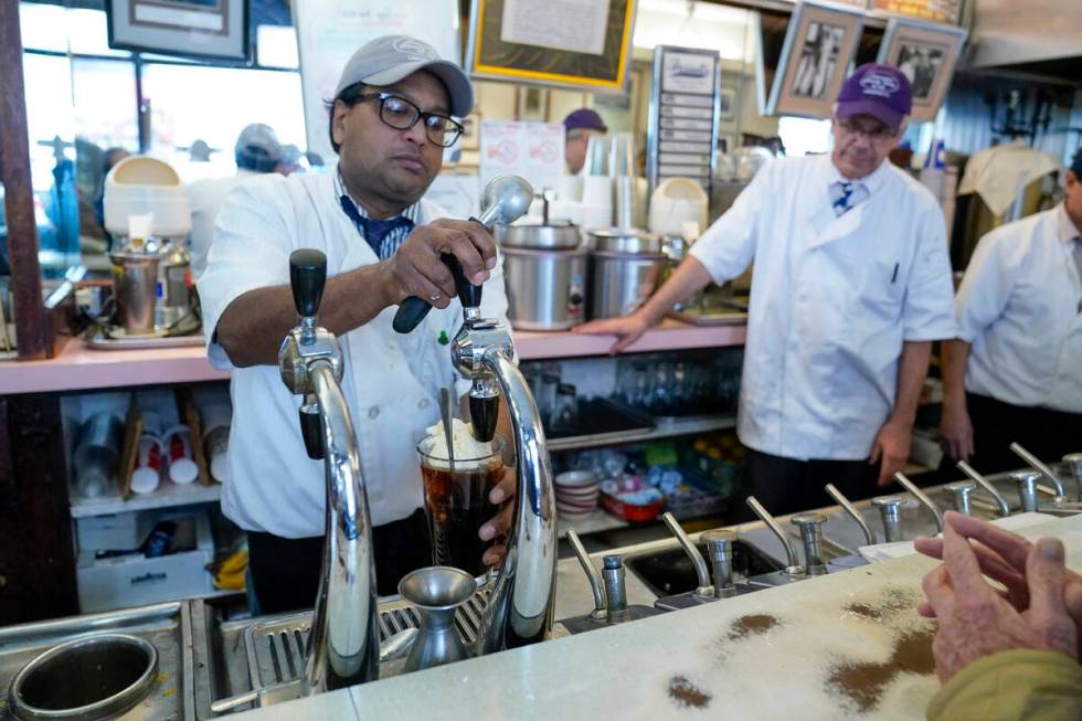 File - An employee of the Lexington Candy Shop prepares a Coke float at the luncheonette on Sep ...