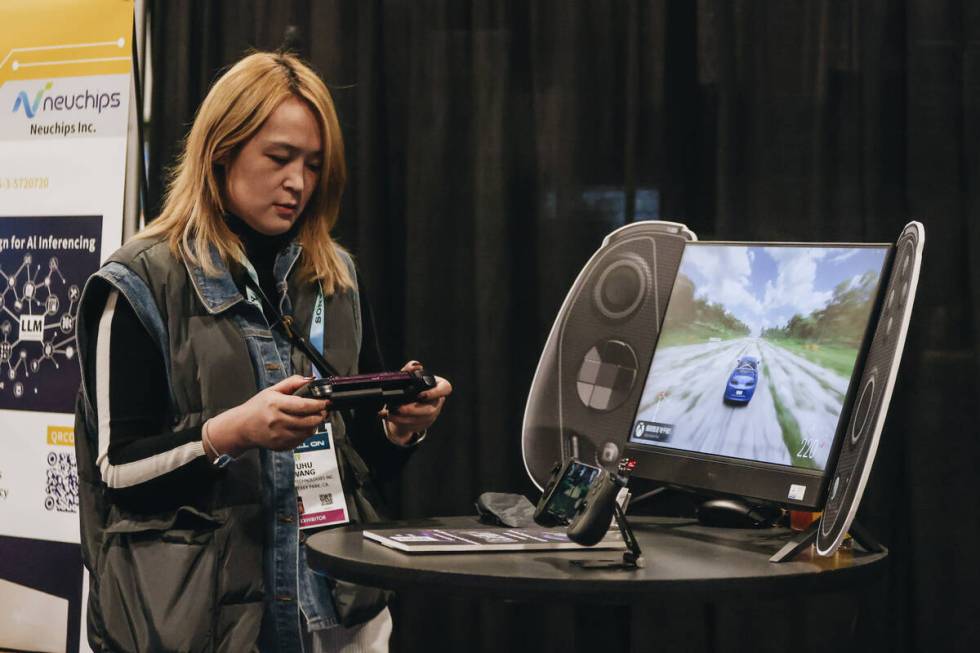 An CES attendee tries a “cloud gaming controller” by Serafim during CES Unveiled ...