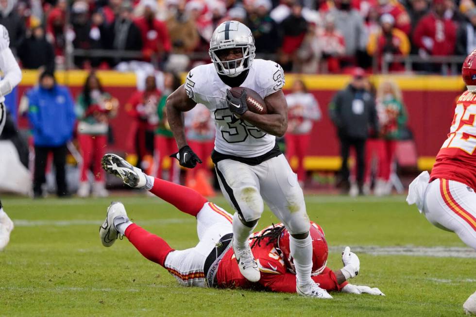 Las Vegas Raiders running back Zamir White (35) runs against Kansas City Chiefs defensive end M ...