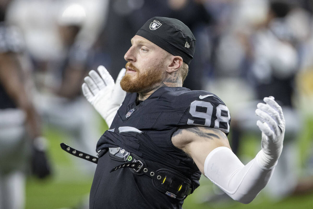 Raiders defensive end Maxx Crosby (98) stretches before an NFL game against the Los Angeles Cha ...