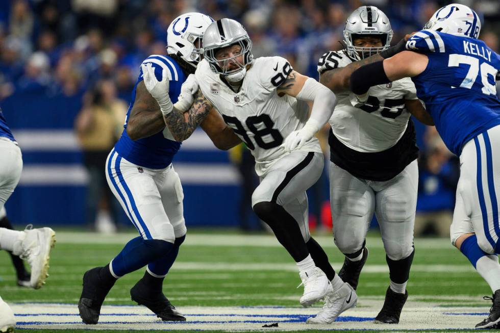 Las Vegas Raiders defensive end Maxx Crosby (98) breaks through the line during an NFL football ...