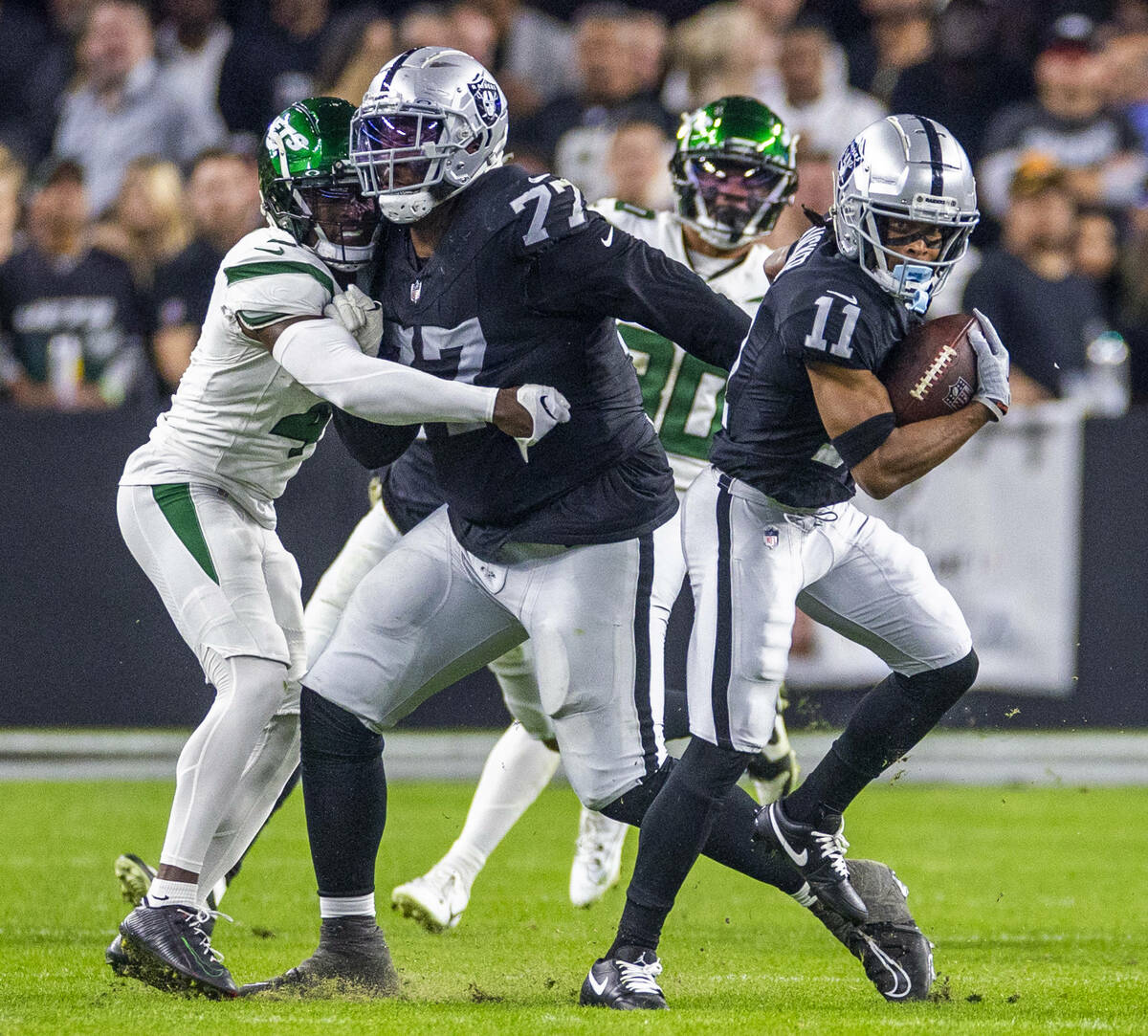 Raiders wide receiver Tre Tucker (11) breaks free for a first down with a block by offensive ta ...