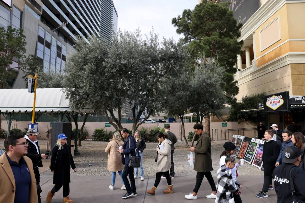 Pedestrians walk past a sliver of land between the Bellagio and The Cosmopolitan is shown on th ...