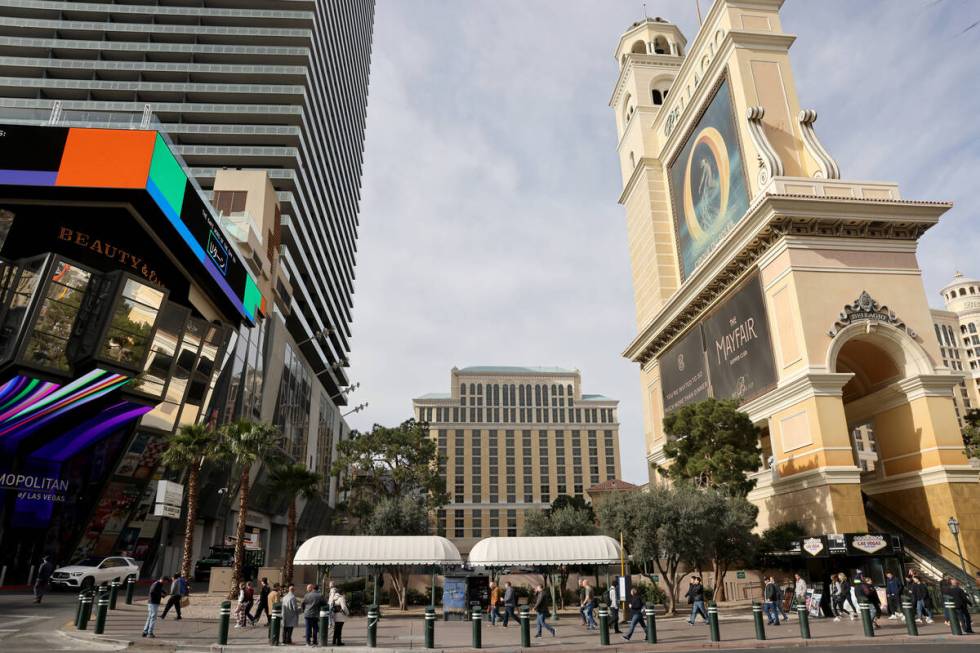 Pedestrians walk past a sliver of land between the Bellagio and The Cosmopolitan is shown on th ...