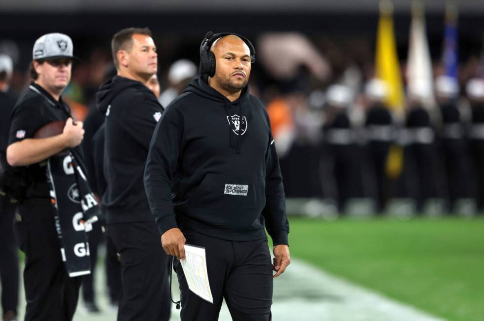 Las Vegas Raiders interim head coach Antonio Pierce stands on the sideline before an NFL footba ...