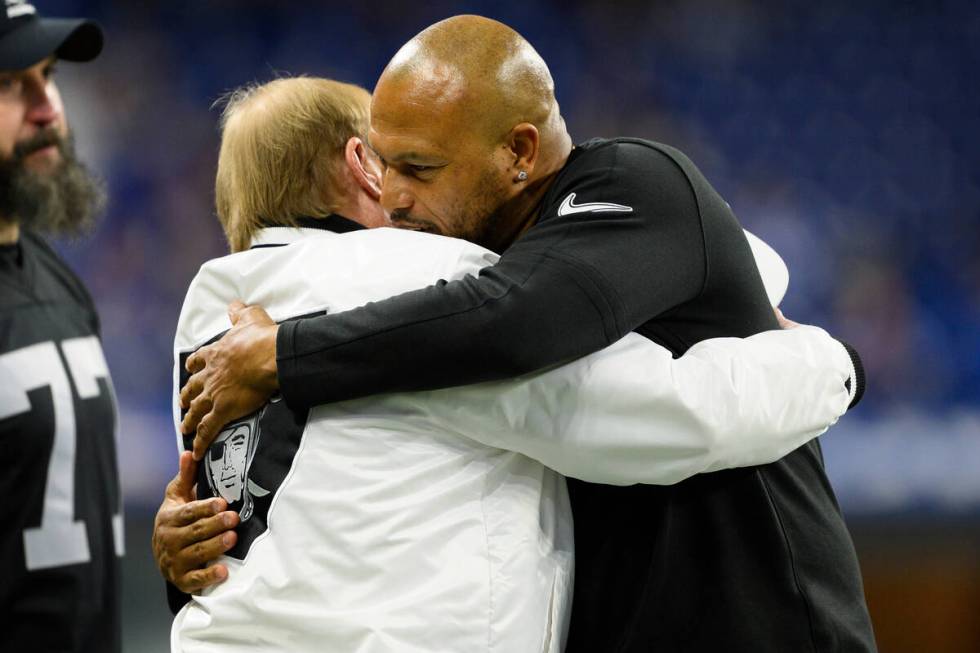 Las Vegas Raiders interim head coach Antonio Pierce and Las Vegas Raiders owner Mark Davis hug ...