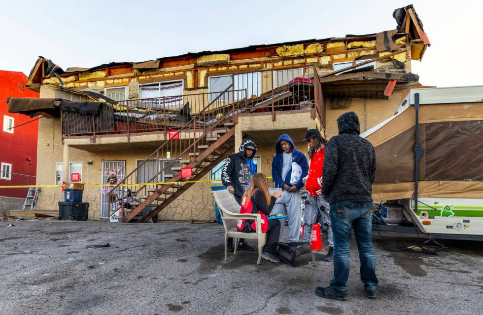 The Red Cross assists those displaced by an apartment building roof collapse near Carey Avenue ...