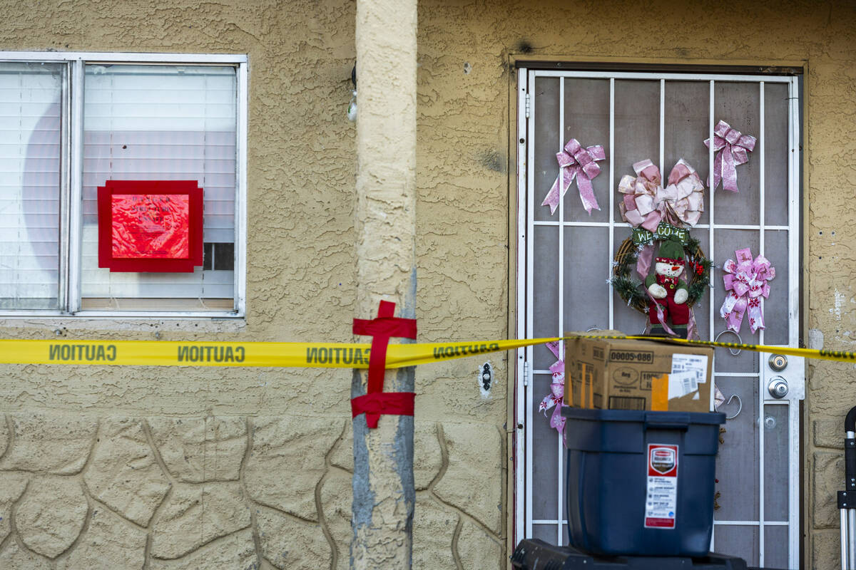 Caution tape and dander signs temporarily keep residents from entering after an apartment build ...