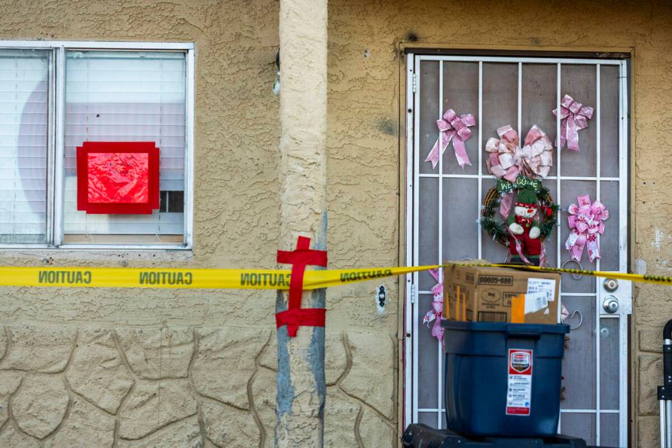 Caution tape and dander signs temporarily keep residents from entering after an apartment build ...