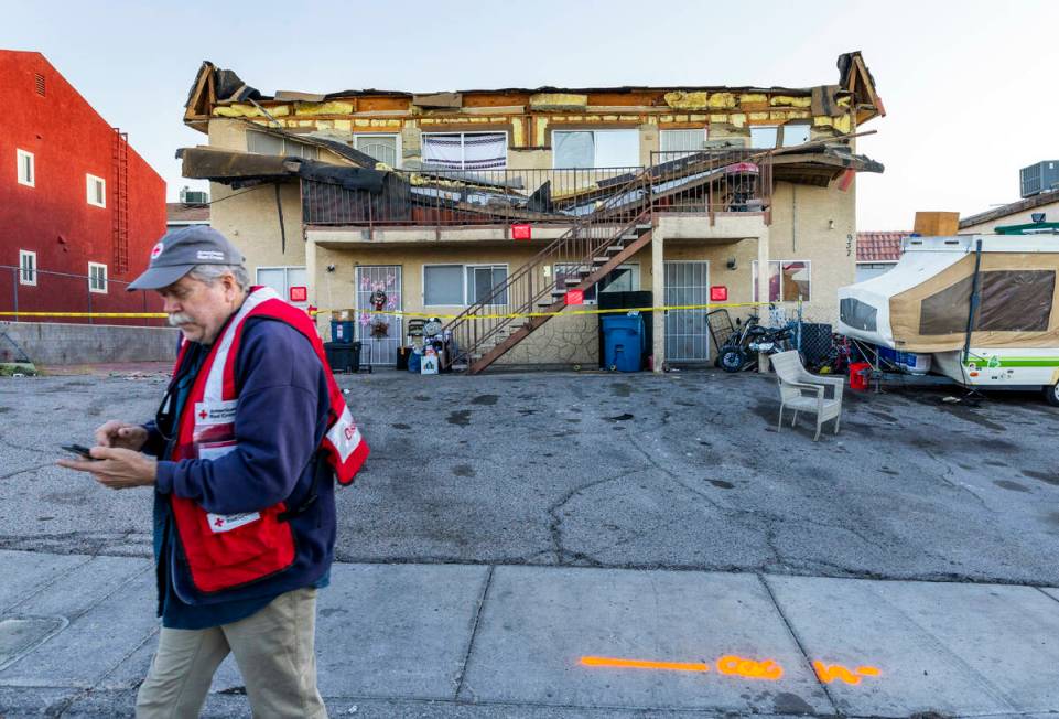 The Red Cross assists those displaced by an apartment building roof collapse near Carey Avenue ...