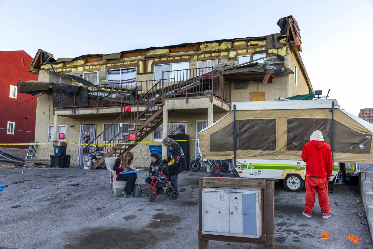 The Red Cross assists those displaced by an apartment building roof collapse near Carey Avenue ...