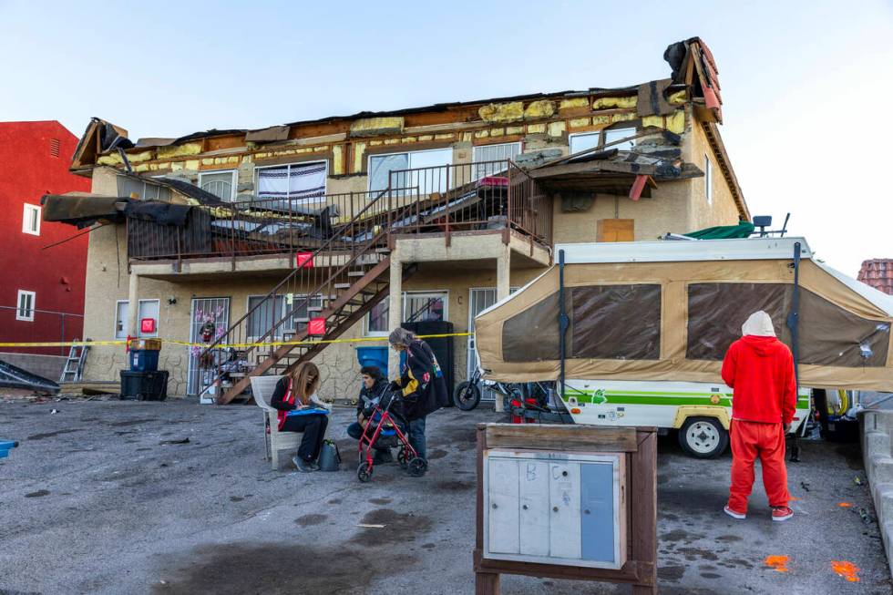 The Red Cross assists those displaced by an apartment building roof collapse near Carey Avenue ...