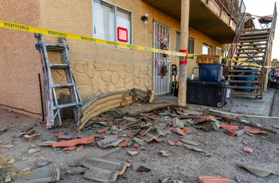 Roof tiles and other debris are scattered about from an apartment building roof collapse near C ...