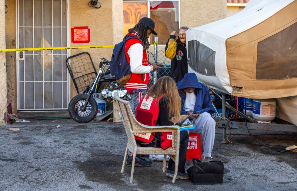 The Red Cross assists those displaced by an apartment building roof collapse near Carey Avenue ...