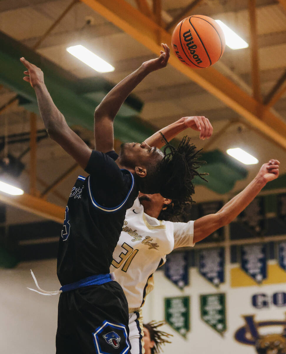 Desert Pines forward Damonte Duhart (3) reaches for the ball during a game at Spring Valley Hig ...