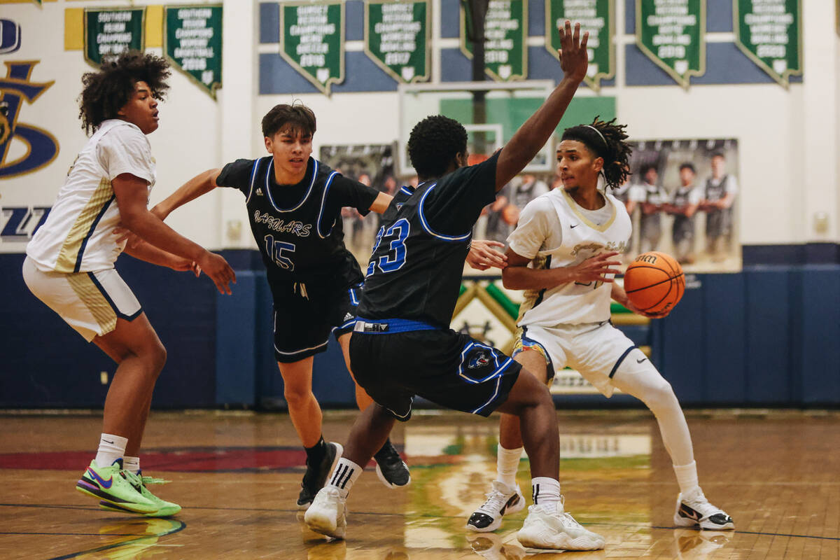 Spring Valley point guard Alijah Adem (31) looks to pass the ball during a game against Desert ...