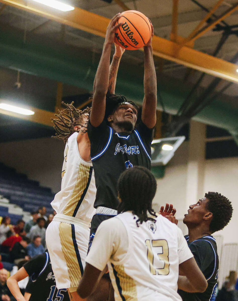Desert Pines forward Damonte Duhart (3) fights for the ball to get a rebound during a game at S ...