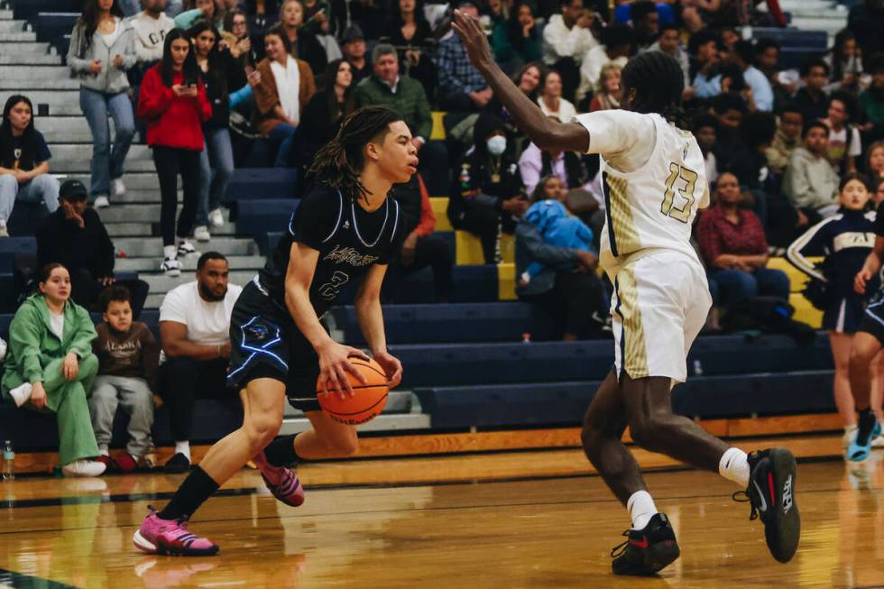 Desert Pines guard Curtis Coleman (2) dribbles the ball as he looks to a teammate during a game ...