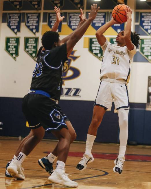 Spring Valley point guard Alijah Adem (31) attempts a shot into the basket during a game agains ...