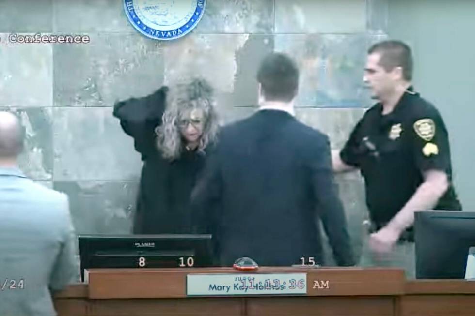 This is a video screen shot of Judge Mary Kay Holthus being aided after she was attacked by def ...