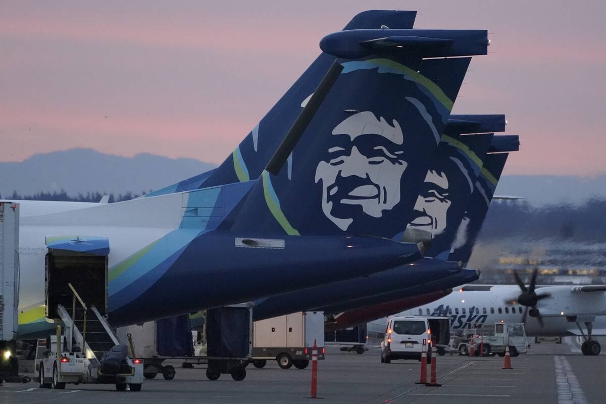 FILE - Alaska Airlines planes are shown parked at gates at sunrise, March 1, 2021, at Seattle-T ...