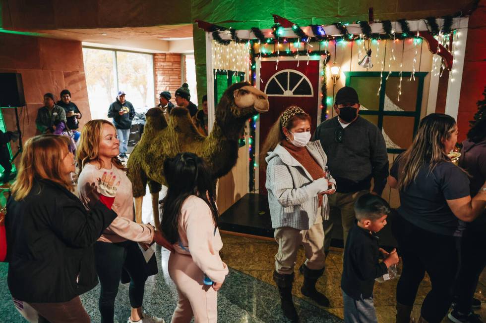 People walk by a fake camel during a Clark County celebration for Three Kings Day at the Clark ...