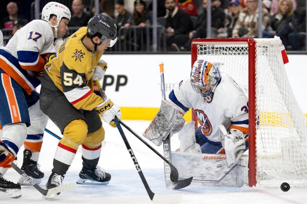 Golden Knights left wing Grigori Denisenko (54) battles at the net against Islanders goaltender ...