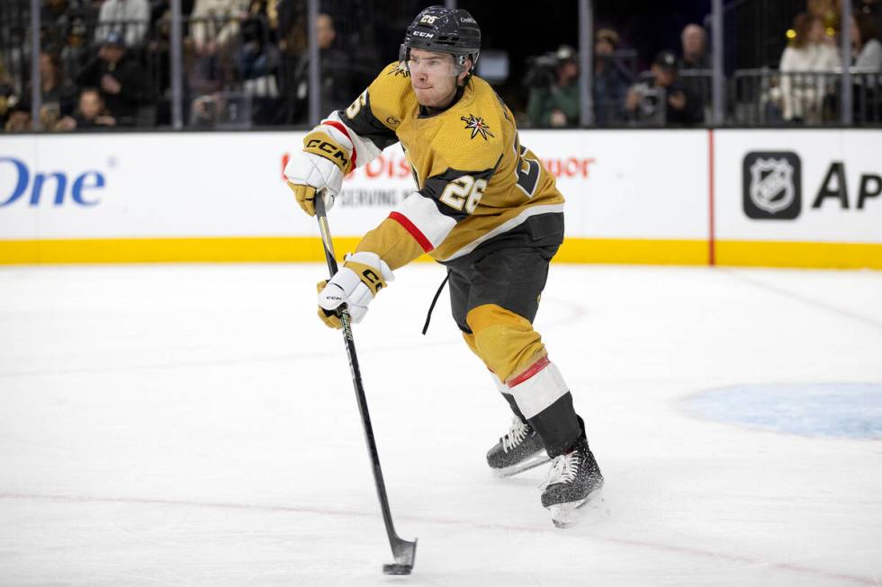 Golden Knights defenseman Tobias Bjornfot (26) skates with the puck during the second period of ...