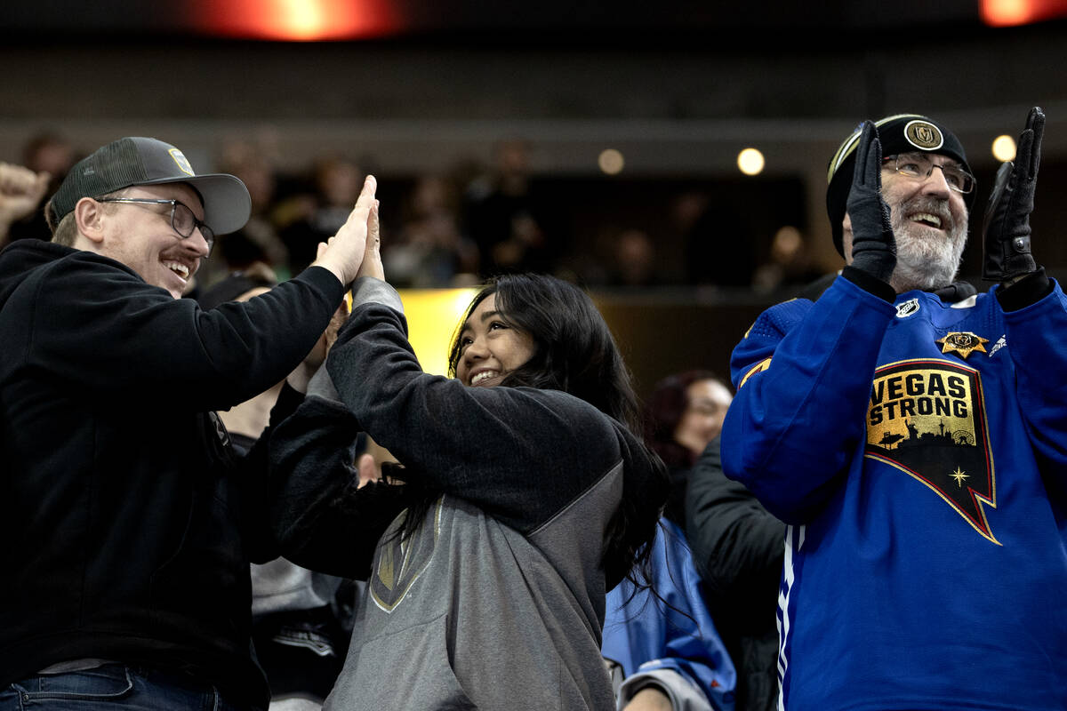 Golden Knights fans celebrate a goal during the second period of an NHL hockey game against the ...