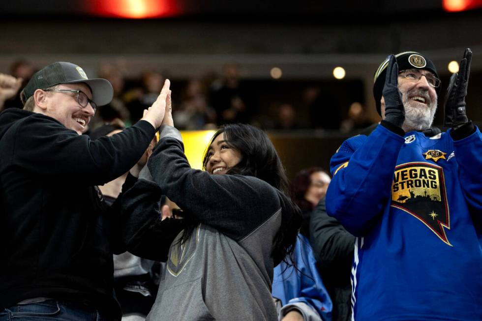 Golden Knights fans celebrate a goal during the second period of an NHL hockey game against the ...