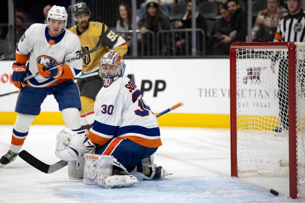 Islanders goaltender Ilya Sorokin (30) looks back at the puck as Golden Knights center Nicolas ...