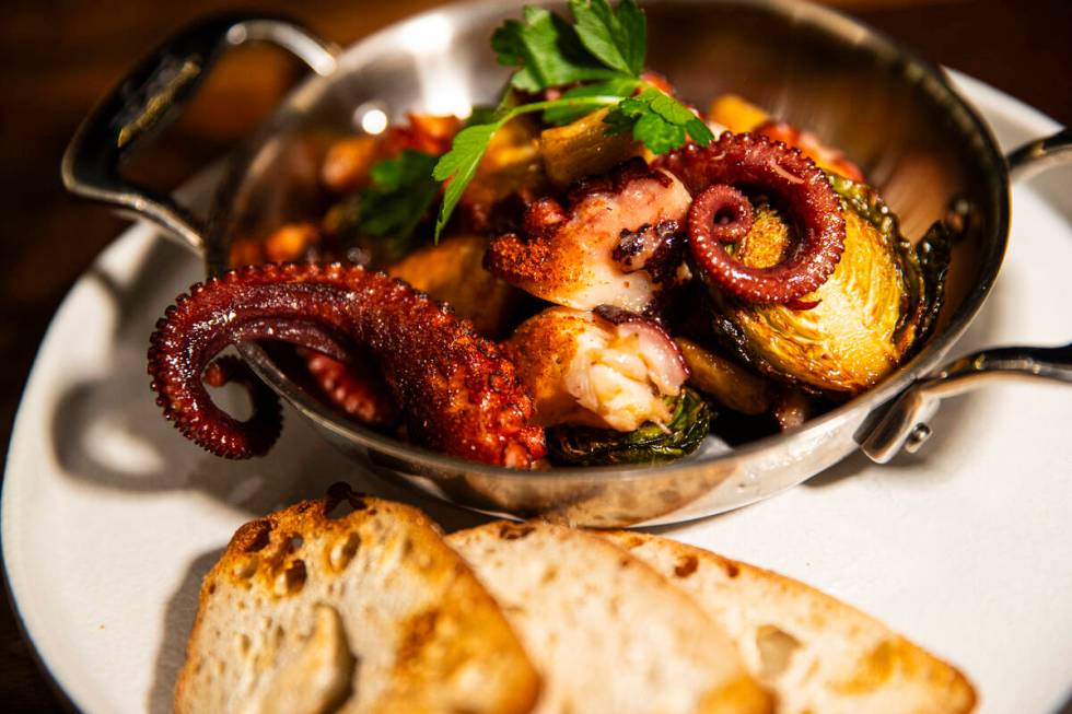 Flambéed octopus is pictured at Casa de Raku, a tapas bar, on Tuesday, Jan. 9, 2024, in La ...