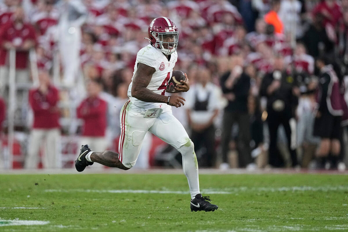 Alabama quarterback Jalen Milroe (4) carries against Michigan during the second half in the Ros ...