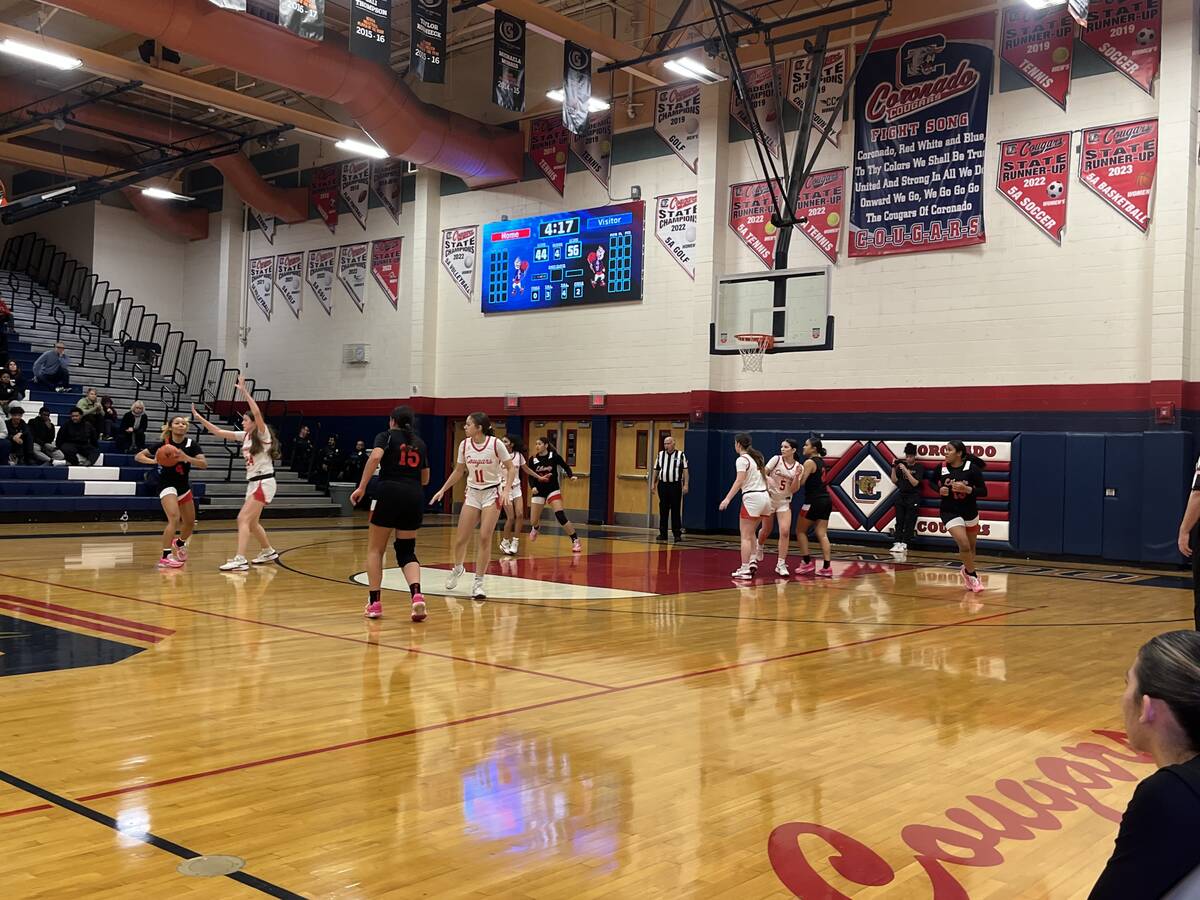 Liberty's girls basketball team shoots a 3-pointer in the second half of its 63-49 win over Cor ...