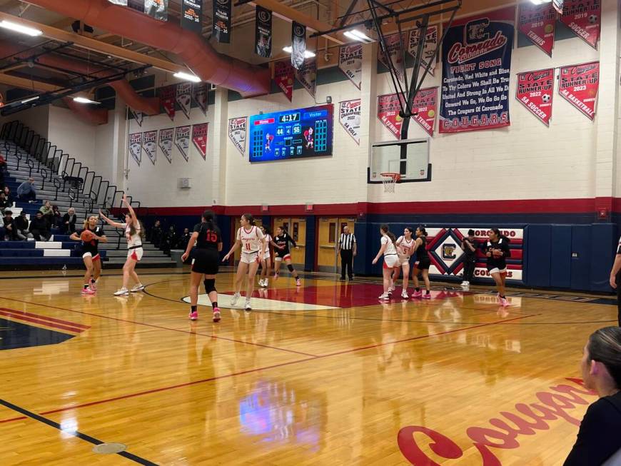 Liberty's girls basketball team shoots a 3-pointer in the second half of its 63-49 win over Cor ...