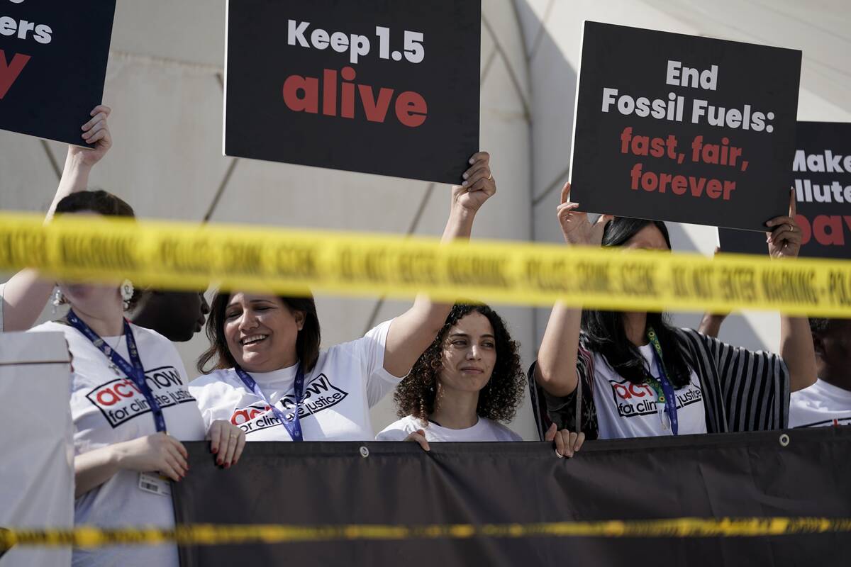 Activists protest against fossil fuels at the COP28 U.N. Climate Summit, Dec. 5, 2023, in Dubai ...